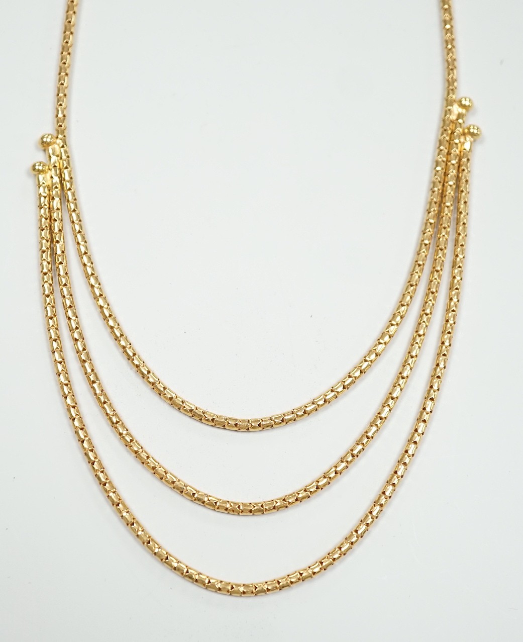 A modern 18ct gold three strand necklace, 43cm, 15.5 grams.